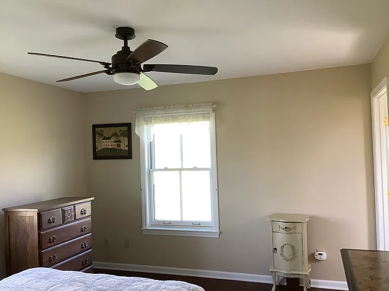 Bedroom area with ceiling fan.