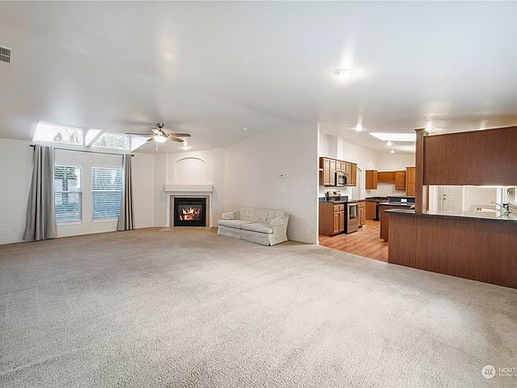 Photo taken from front door. Looking at the propane fireplace.>