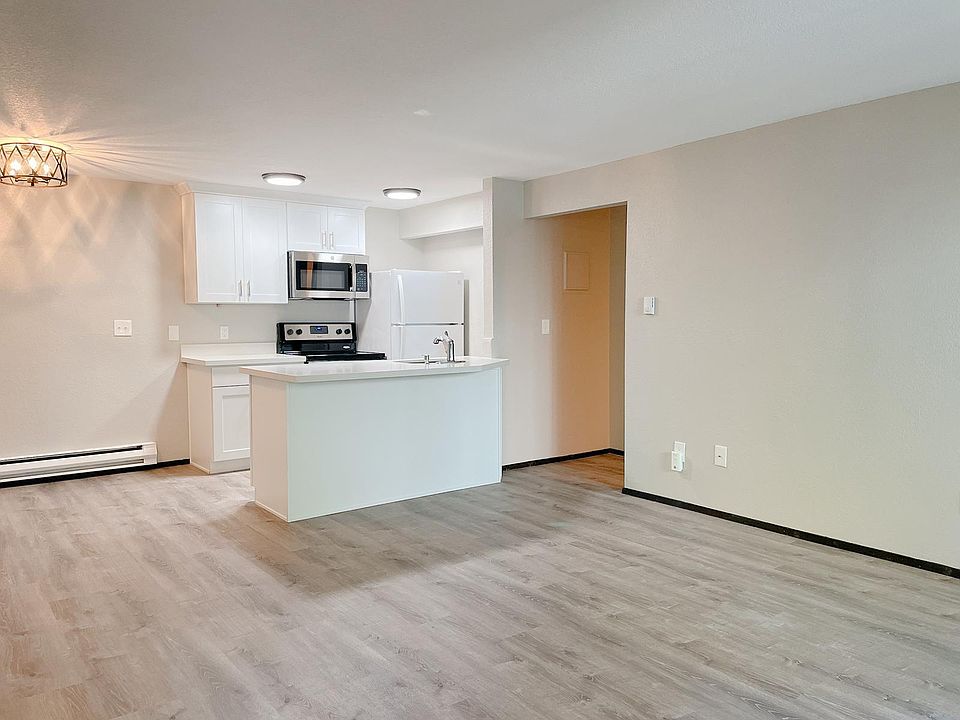 Living, dining, and kitchen. New flooring and paint.