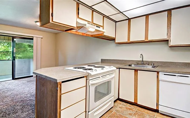 Milton Apartments - Autumn Village Apartments - Living Room, Kitchen, and Deck