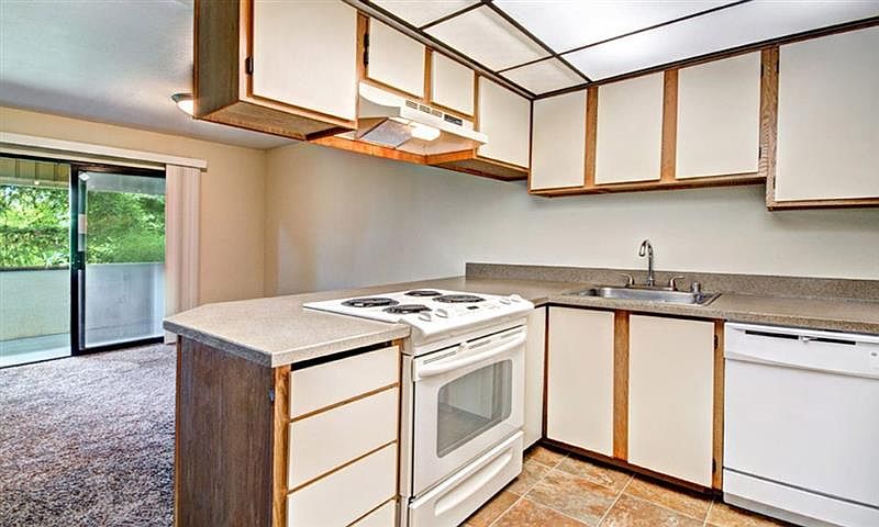 Milton Apartments - Autumn Village Apartments - Living Room, Kitchen, and Deck
