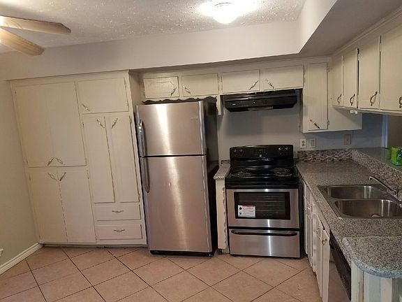 Kitchen counter and cabinets with stainless appliances (2)