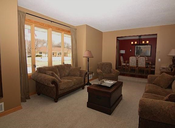 Sunken formal living room offers plenty of room for entertaining, and features a sunlit bay of windows...Windows throughout the home have been replaced with Renewal by Anderson top quality windows!