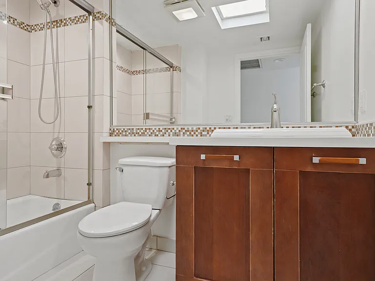 Bathroom with Full-Size Bathtub and Cabinet Storage