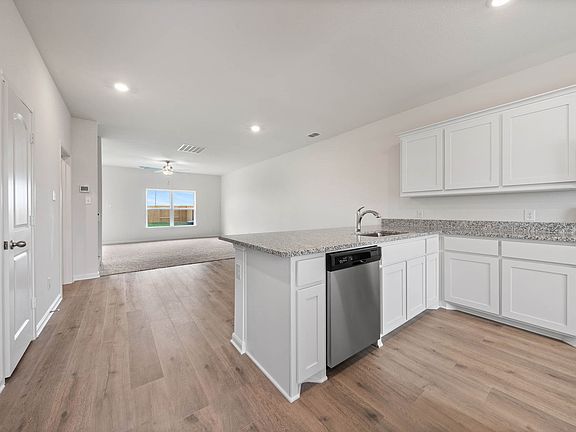 The dining room of the Driftwood sits in betweent the kitchen and the family room.