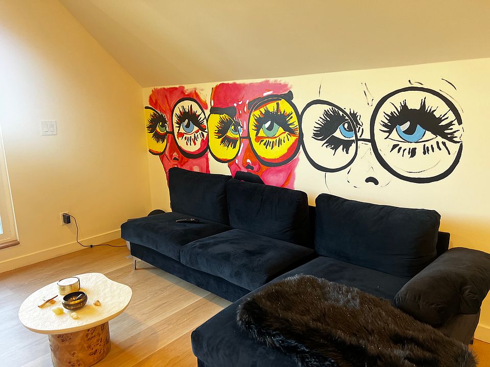 Living room has a local artist Mural on the walls.