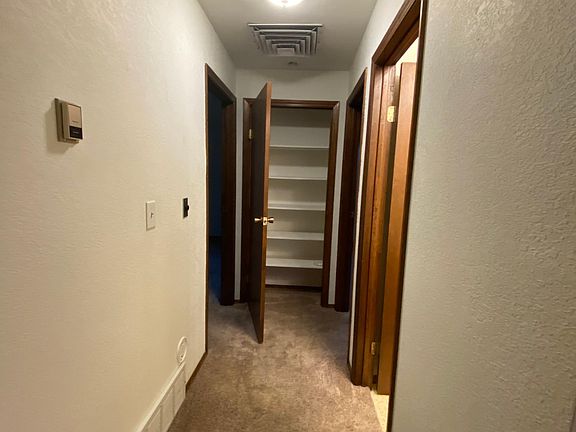 Hallway with storage closet