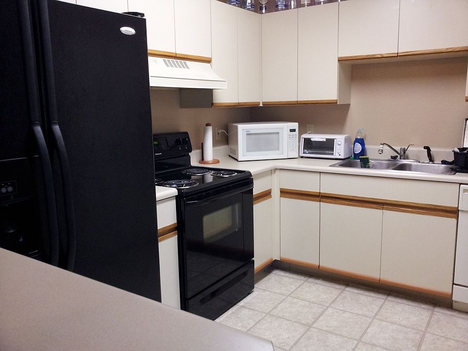 Kitchen with side by side refrigerator