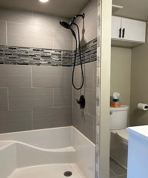 Additional cabinet above toilet, multi-setting, wand sprayer shower.