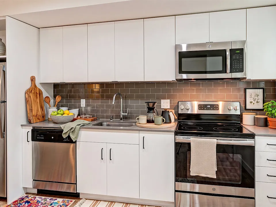 A full-size stainless appliance package and generous counter space, with daylight from a side window.