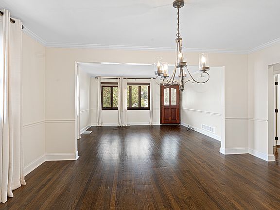 Elegant rooms with gleaming hardwood flooring, crown, & chair rail.