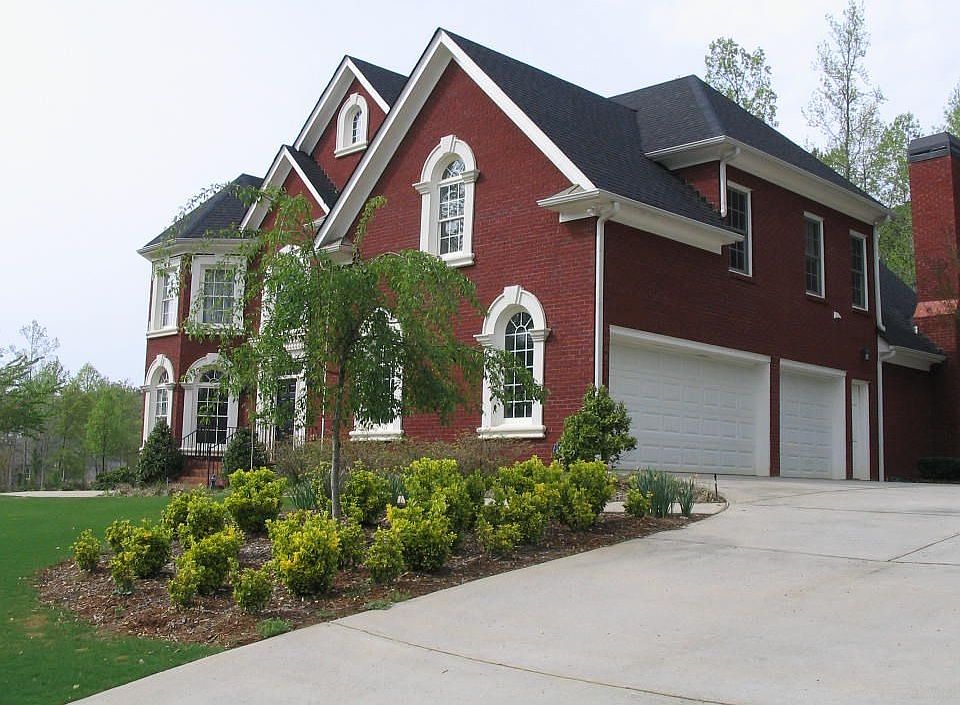 Front view of house and 3 car garage.
