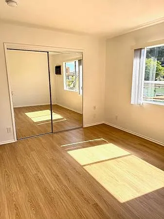 Large and sunny bedrooms with large closets. This bedroom also has floor-to-ceiling shelving. So. Much. Storage!
