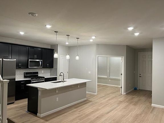 Main level study with all luxury vinyl hardwood floors and powder bath.