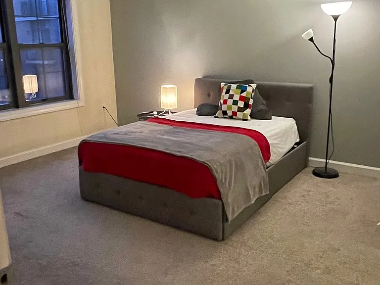 Bedroom with 2 large windows looking into the interior landscaped yard.
