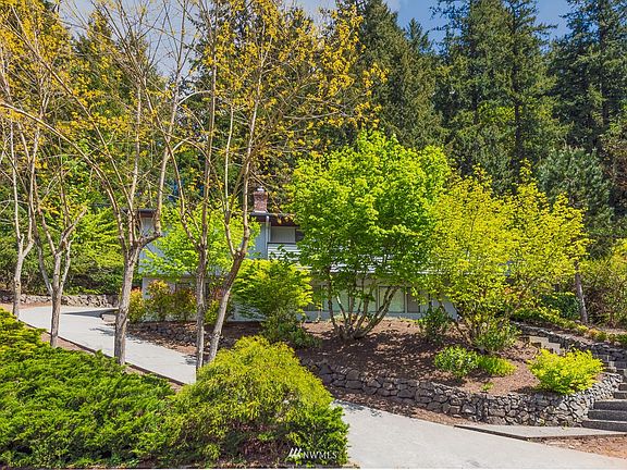 Mature landscaping including locust trees.