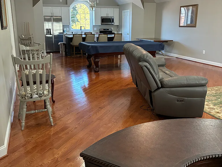 Great Room with kitchen, pool table, media area, and custom desk.