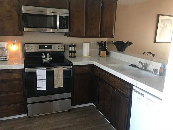 Fully stocked kitchen with new electric stove.