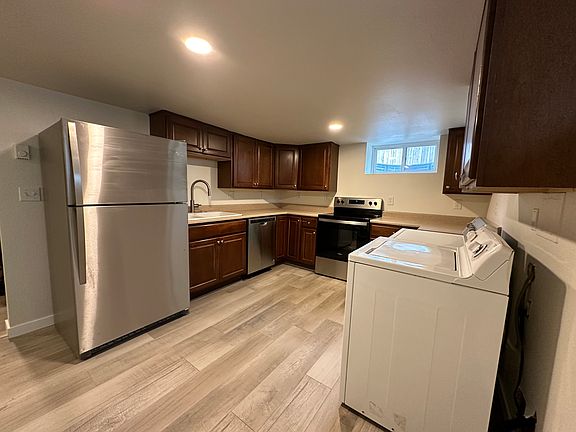 Kitchen with washer/dryer and new stainless steel appliances