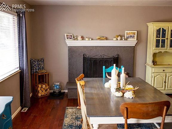 Living room with hardwood floors and wood fireplace