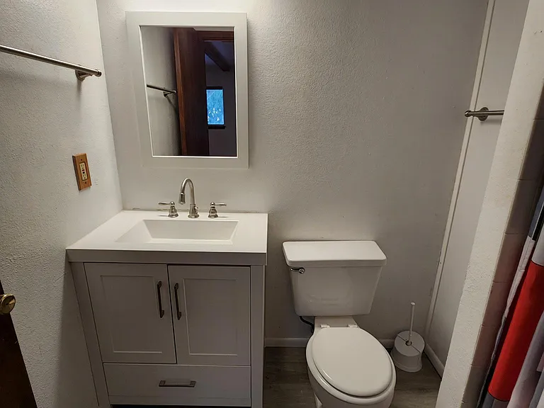 Newly remodeled vanity in downstairs bath with shower.