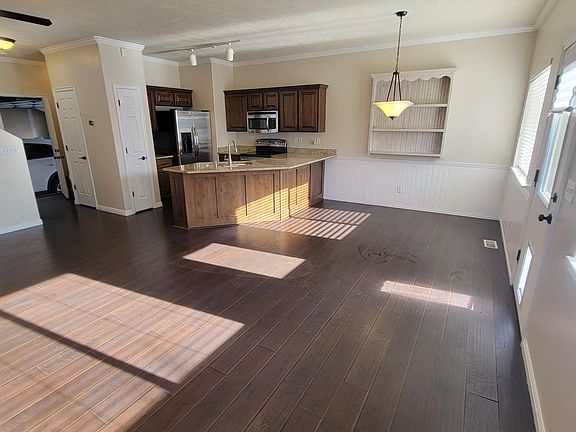 This photo highlights the same open-concept kitchen, living and dining space from a different perspective.
