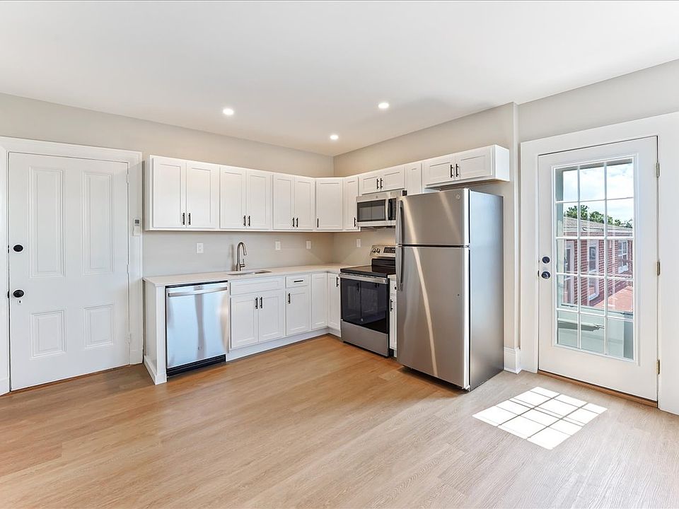Brand new kitchen with white shaker cabinets and stainless steel appliances. Recessed lighting.