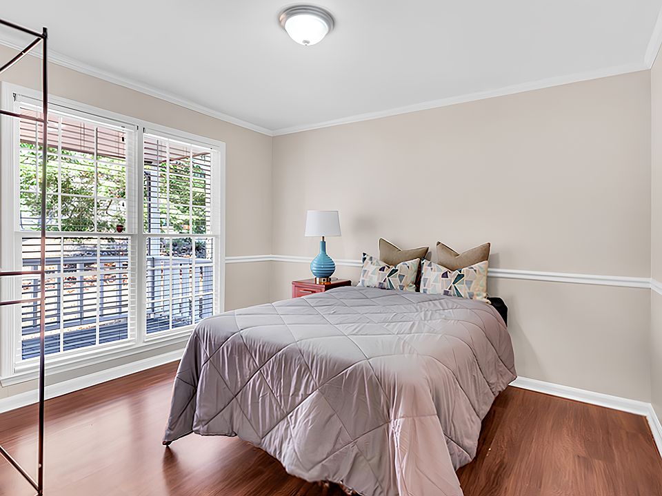 Main level bedroom with large windows.