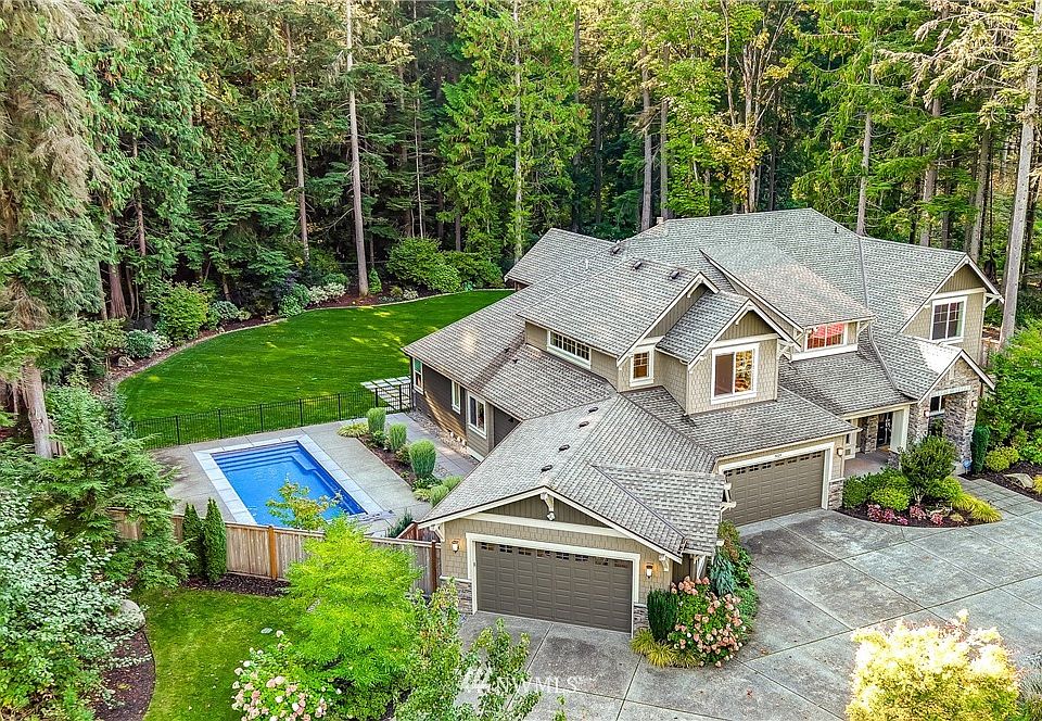 Level, fully fenced 3.4 acres with an in-ground pool and greenbelt in front and behind in the Meadowood community in Redmond.