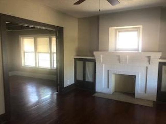 Living room open to large dining room with french doors.