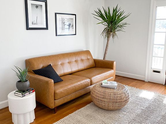 The wall opposite the fireplace in the living room. Walls are painted throughout in a lovely shade of museum grey with crisp white trim.