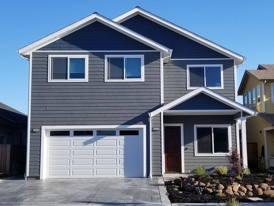 View of the front of the house. the ADU entrance is around the left of the garage