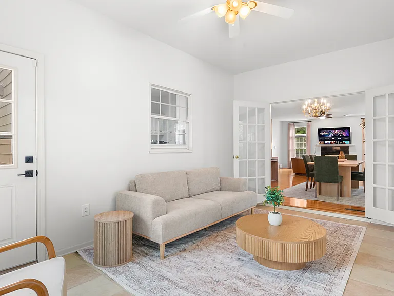 Bright sunroom with comfortable seating and plenty of natural light for relaxing or enjoying morning coffee.