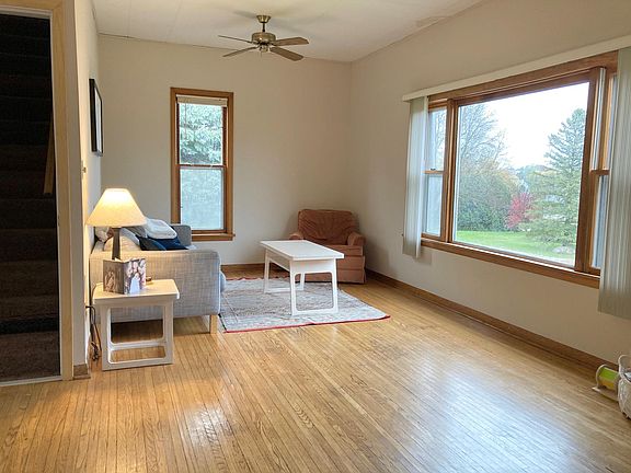 Main floor living room with hardwood floor & more natural light