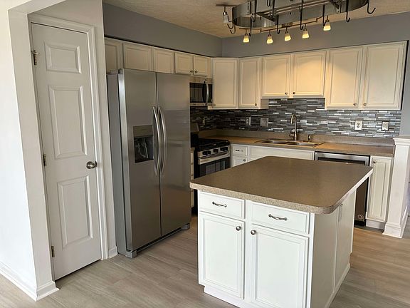 New stainless steel appliances throughout the kitchen.