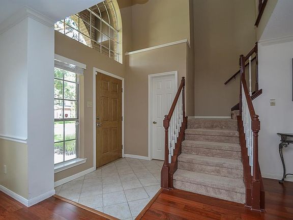 Such a beautiful open floor plan for welcoming friends and family. Two story windows add inviting light into the entrance of the home.