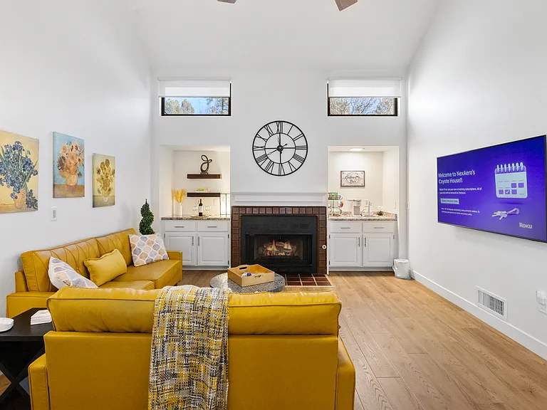 The living room features a cozy gas fireplace and a large smart TV