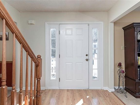 Spacious Foyer with Hardwood Flooring to Greet Family and Friends