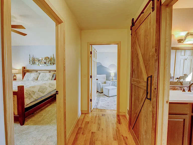 Upstairs hallway with a bedroom on each side of the full bathroom.