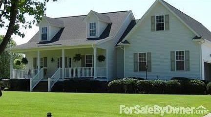 Front View of House
						:
						Rocking chair front porch
Manicured lawn with shrubbery, flowers and trees