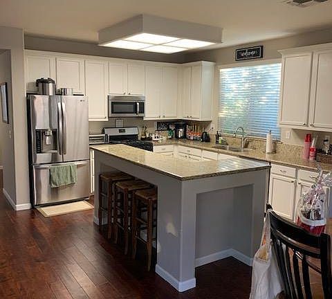 Open kitchen area adjacent to living room and dining room