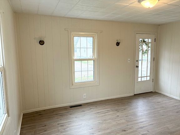 Living room with new floor, fresh paint, and great natural lighting