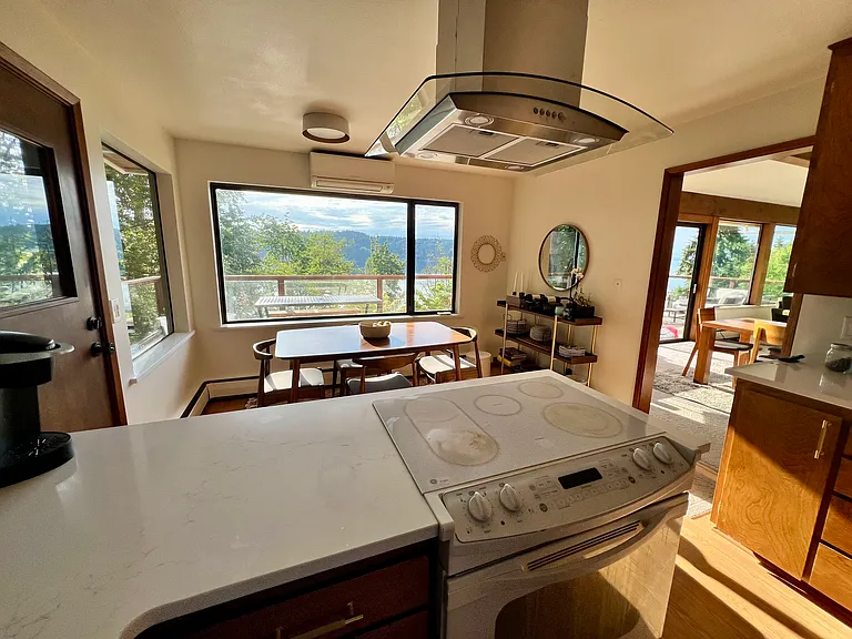 Kitchen with Quartz counters, electric cooktop/ oven, stainless steel appliances, and amazing views.