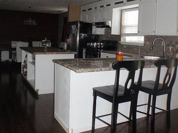 custom cabinets with oversized island   built in wine rack