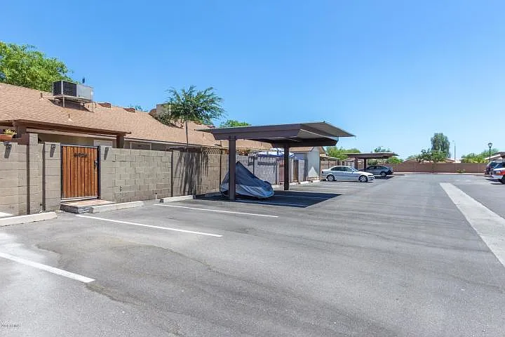 One covered parking space at the back of the townhome. You can park right at your gate to the private patio.