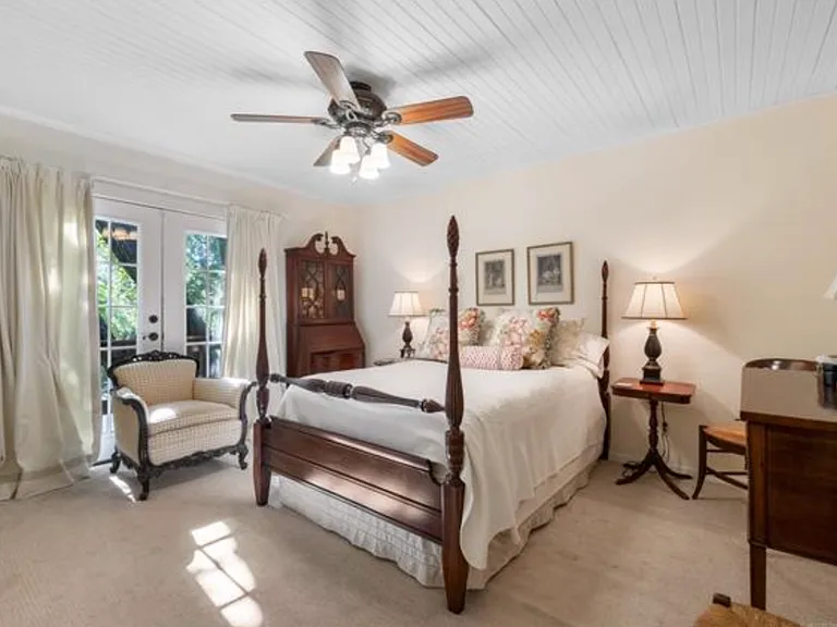 Top floor bedroom with French doors to private balcony.