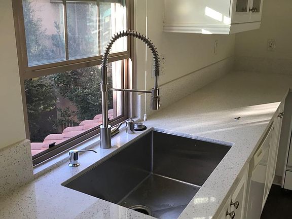 Brand new deep stainless steel kitchen sink and faucet.