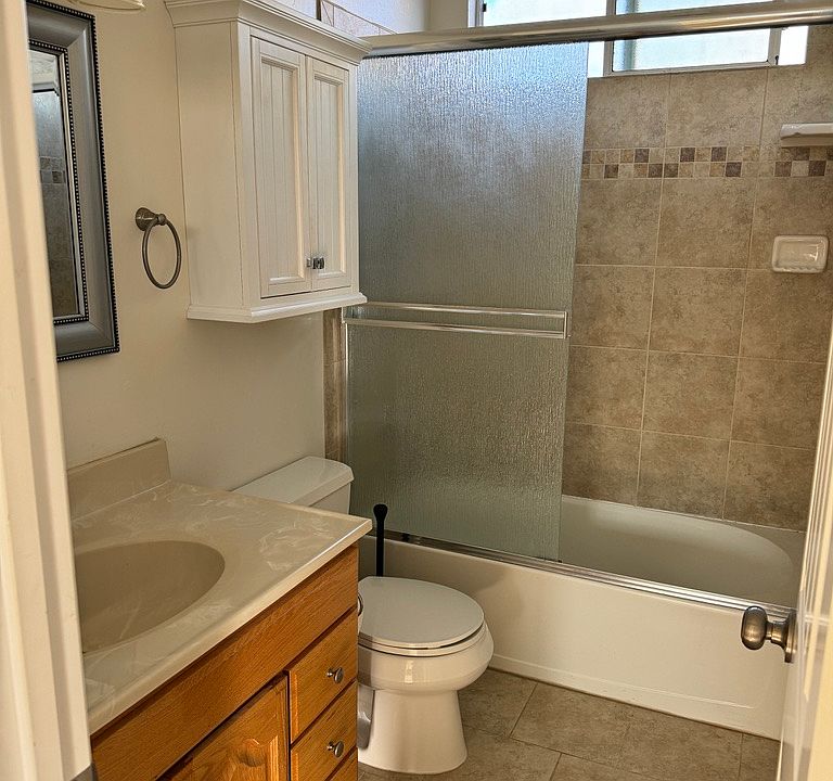 updated bathroom with tile and lots of storage