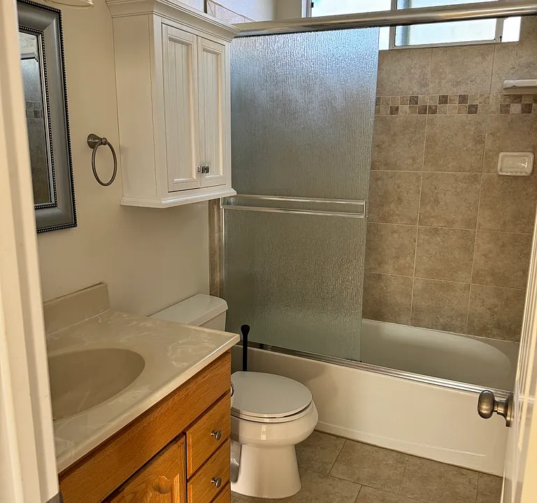 updated bathroom with tile and lots of storage