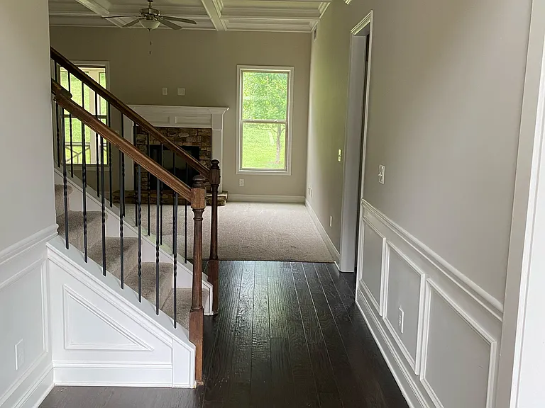 Hardwood floor entrance, wain scotting, Fire Place in Family Room